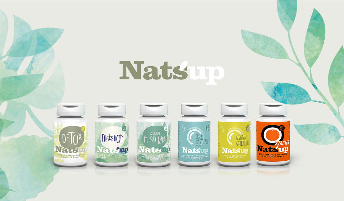 Six bouteilles de compléments alimentaires Natsup avec des étiquettes aux couleurs pastel sont alignées sur un fond blanc avec des feuilles d'aquarelle vertes et le logo Natsup au-dessus - parfait pour toute création de catalogue présentant une variété de noms de produits.